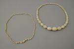 Deux COLLIERS en IVOIRE formés de perles de forme olive...