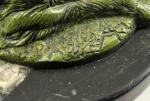 AUGROS (actif au XXe siècle)Chien couché.Bronze à patine verte, signé...