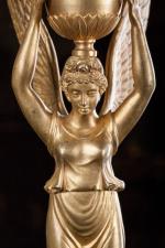 PAIRE de CANDÉLABRES en bronze doré en forme de Victoires...