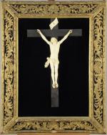 CHRIST en croix en ivoire sculpté. Dans un CADRE en...