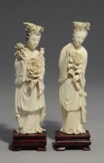 Deux STATUETTES en ivoire sculpté représentant une femme portant des...