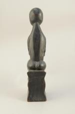 STATUETTE en bois sculpté et noirci.Femme stylisée assise.Haut. 43, Larg....