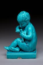 D'après Jean-Baptiste PIGALLE (1714-1785)"Fillette à l'oiseau"en céramique émaillée monochrome bleu...